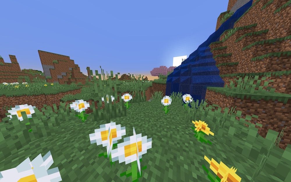 Nice scenic waterfall with oxeye daisies and a cherry blossom tree covering the setting sun
